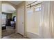 Bathroom featuring a shower-tub combo, tile floors, and a door leading to another room at 12814 W Edgemont Ave, Avondale, AZ 85392