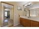 Bathroom featuring tile floors, a vanity, a mirror, and a view into another room at 12814 W Edgemont Ave, Avondale, AZ 85392