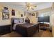 Bedroom featuring a large bed, ceiling fan, and a desk area at 12814 W Edgemont Ave, Avondale, AZ 85392