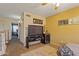 Cozy bedroom featuring a ceiling fan, television, and doorway leading to the rest of the house at 12814 W Edgemont Ave, Avondale, AZ 85392