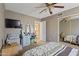 This bedroom features a ceiling fan, bed, and a desk overlooking the rest of the house at 12814 W Edgemont Ave, Avondale, AZ 85392