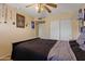 A bedroom with a dark wooden bed frame and a sliding closet door at 12814 W Edgemont Ave, Avondale, AZ 85392