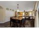 Open dining and living area featuring a large table, hardwood floors, and lots of natural light at 12814 W Edgemont Ave, Avondale, AZ 85392