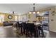 Open dining and living area featuring a large table, hardwood floors, and backyard view at 12814 W Edgemont Ave, Avondale, AZ 85392
