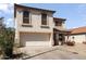 Inviting two-story home with a two-car garage, desert landscaping, and a cozy front porch at 12814 W Edgemont Ave, Avondale, AZ 85392