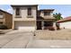 Charming two-story home featuring stucco siding, a two-car garage, and low maintenance desert landscaping at 12814 W Edgemont Ave, Avondale, AZ 85392