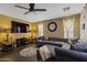 Relaxing living room featuring a comfy sectional, ceiling fan, and ample natural light at 12814 W Edgemont Ave, Avondale, AZ 85392