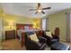 Comfortable main bedroom featuring neutral paint, a ceiling fan, and sitting chairs at 12814 W Edgemont Ave, Avondale, AZ 85392