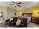 Spacious main bedroom featuring a ceiling fan, two chairs, and neutral paint at 12814 W Edgemont Ave, Avondale, AZ 85392