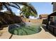 Backyard with clear, clean pool, surrounding concrete decking and privacy wall at 12814 W Edgemont Ave, Avondale, AZ 85392