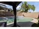 This backyard features a clear swimming pool, mature shade trees, and a covered patio at 12814 W Edgemont Ave, Avondale, AZ 85392