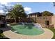 Inviting backyard pool featuring a textured concrete deck, tiled accents, and a mature palm tree, perfect for outdoor enjoyment at 12814 W Edgemont Ave, Avondale, AZ 85392