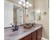 Bathroom featuring double sinks, dark wood cabinets, granite countertops, and vanity lighting at 13131 N 153Rd Ave, Surprise, AZ 85379