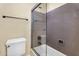 Bathroom featuring a tiled shower, toilet, towel bar, and tiled accents at 13131 N 153Rd Ave, Surprise, AZ 85379