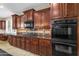 Well-appointed kitchen featuring sleek black appliances, a gas cooktop, and ample storage space at 13131 N 153Rd Ave, Surprise, AZ 85379