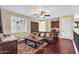 Cozy living room with dark wood floors, a ceiling fan, dark wood furniture and light paint at 13131 N 153Rd Ave, Surprise, AZ 85379