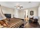 Comfortable main bedroom with wood floors, a ceiling fan, and a sitting area at 13131 N 153Rd Ave, Surprise, AZ 85379