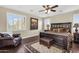 Serene main bedroom with a king-size bed, plush seating, and plantation shutters for a tranquil retreat at 13131 N 153Rd Ave, Surprise, AZ 85379