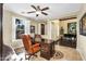 Well-lit home office with an elegant wooden desk, ceiling fan, and tile flooring at 13131 N 153Rd Ave, Surprise, AZ 85379