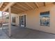 Covered back patio featuring neutral stucco walls, perfect for outdoor relaxation and entertainment at 1350 E Vaughn Ave, Gilbert, AZ 85234