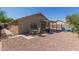The backyard showcases patio seating, a BBQ grill, and a cozy conversation area with rock landscaping at 1350 E Vaughn Ave, Gilbert, AZ 85234