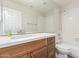 Bathroom with wood cabinets, white countertop, shower/bath, and a large mirror at 1350 E Vaughn Ave, Gilbert, AZ 85234