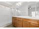 Bathroom features a double sink vanity with wood cabinets and a glass enclosed shower at 1350 E Vaughn Ave, Gilbert, AZ 85234