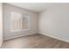 Bedroom is a blank canvas with a window for natural light and wood-look floors at 1350 E Vaughn Ave, Gilbert, AZ 85234