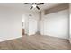 Spacious bedroom boasts walk-in closet, wood-look floors, and ensuite bathroom access at 1350 E Vaughn Ave, Gilbert, AZ 85234