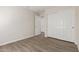 Neutral bedroom featuring wood-look floors, closet, and white doors at 1350 E Vaughn Ave, Gilbert, AZ 85234