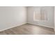 Neutral bedroom boasts wood-look floors and a window for natural light at 1350 E Vaughn Ave, Gilbert, AZ 85234