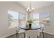 Cozy dining room with natural light, wood floors, and a charming chandelier. Perfect for intimate meals at 1350 E Vaughn Ave, Gilbert, AZ 85234