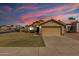 Charming single-story home boasts a well-manicured lawn and neutral-toned exterior with a two-car garage at 1350 E Vaughn Ave, Gilbert, AZ 85234