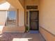 Inviting front entrance with decorative screen door and manicured landscaping at 1350 E Vaughn Ave, Gilbert, AZ 85234