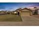 Charming single-story home features a well-manicured lawn and two car garage at 1350 E Vaughn Ave, Gilbert, AZ 85234