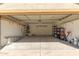 Spacious two car garage featuring built-in shelving and an automatic door at 1350 E Vaughn Ave, Gilbert, AZ 85234