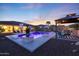 An inviting backyard with a pool, gazebo, grill, patio, seating, and basketball court provides resort-style living at 14979 S 184Th Ave, Goodyear, AZ 85338