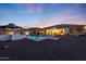 An inviting backyard area featuring a private pool, lounge chairs, outdoor seating, and mature trees at 14979 S 184Th Ave, Goodyear, AZ 85338