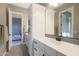 Bright bathroom featuring double sinks, sleek white cabinetry, and modern fixtures at 14979 S 184Th Ave, Goodyear, AZ 85338