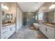 A luxurious bathroom features dual vanities, a modern bathtub, and a separate tiled shower at 14979 S 184Th Ave, Goodyear, AZ 85338