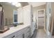 Bright bathroom featuring double sinks, sleek white cabinetry, and modern fixtures at 14979 S 184Th Ave, Goodyear, AZ 85338