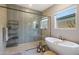 This bathroom showcases a stylish walk-in shower and luxurious soaking tub at 14979 S 184Th Ave, Goodyear, AZ 85338