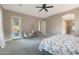 Relaxing bedroom featuring soft chairs, ceiling fan, and an open doorway to an ensuite at 14979 S 184Th Ave, Goodyear, AZ 85338