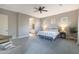 Spacious bedroom with a ceiling fan, three windows, and ensuite bathroom access at 14979 S 184Th Ave, Goodyear, AZ 85338