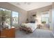 Comfortable bedroom with neutral tones, three windows, and a ceiling fan at 14979 S 184Th Ave, Goodyear, AZ 85338