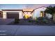 This beautiful home has a well-manicured front yard, a two-car garage, and a cozy front entrance at 14979 S 184Th Ave, Goodyear, AZ 85338