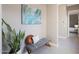 Hallway featuring a decorative bench, modern artwork, and a glimpse into the bedroom at 14979 S 184Th Ave, Goodyear, AZ 85338