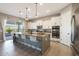 Spacious kitchen featuring an island with bar seating, stainless steel appliances, and modern finishes at 14979 S 184Th Ave, Goodyear, AZ 85338