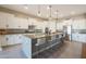 Bright, open kitchen featuring large island with pendant lights, seating, and stainless steel appliances at 14979 S 184Th Ave, Goodyear, AZ 85338