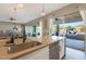 Kitchen island with stainless steel sink and dishwasher, connecting indoor living with outdoor pool area at 14979 S 184Th Ave, Goodyear, AZ 85338